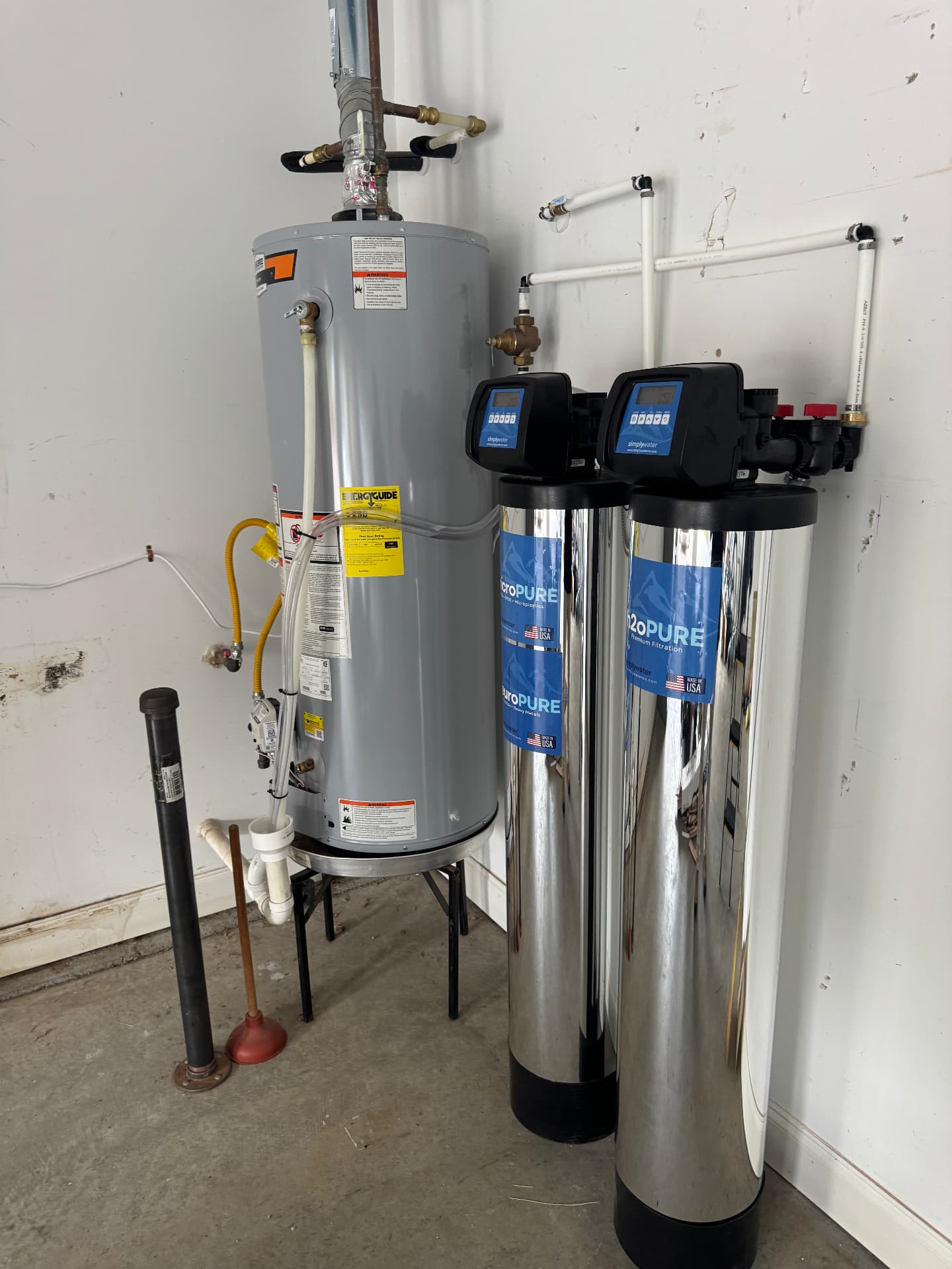 Two-tank Simply Water filtration installation beside a home water heater